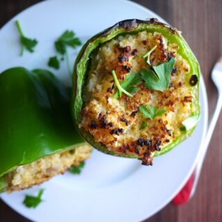 Shows an image of two stuffed green peppers on a white plate